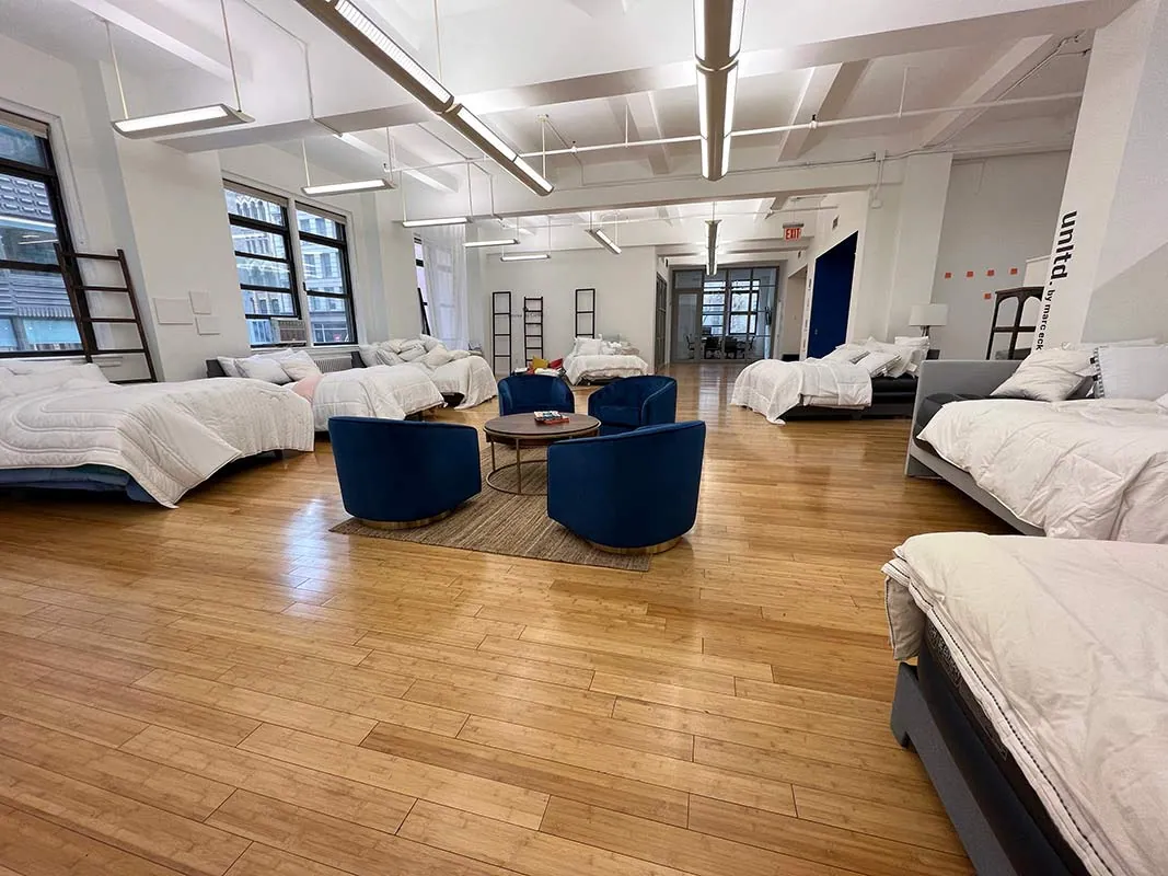 Bedding showroom with a lounge of blue armchairs