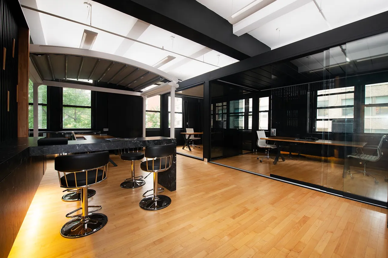 Showroom with black millwork and glass offices