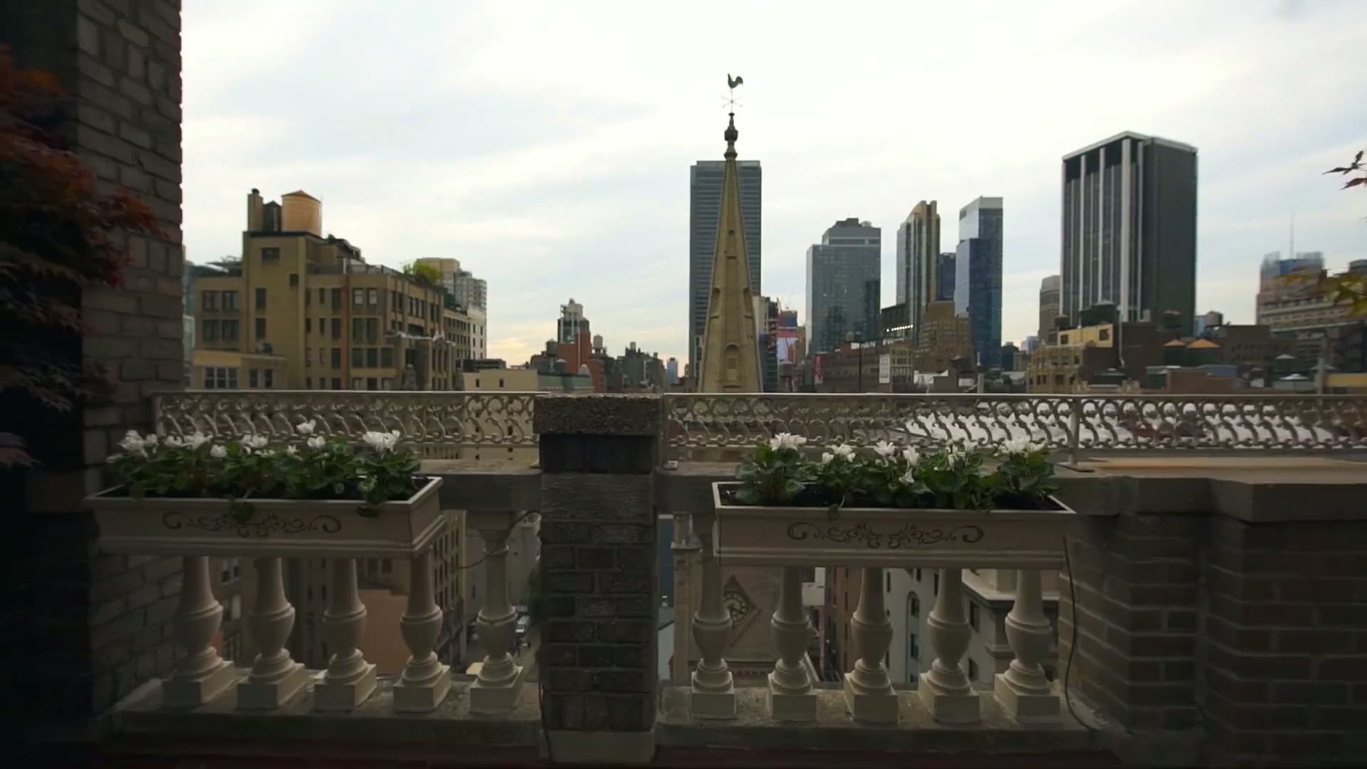 The penthouse terrace balustrade and planters, with the Marble Collegiate Church spire beyond